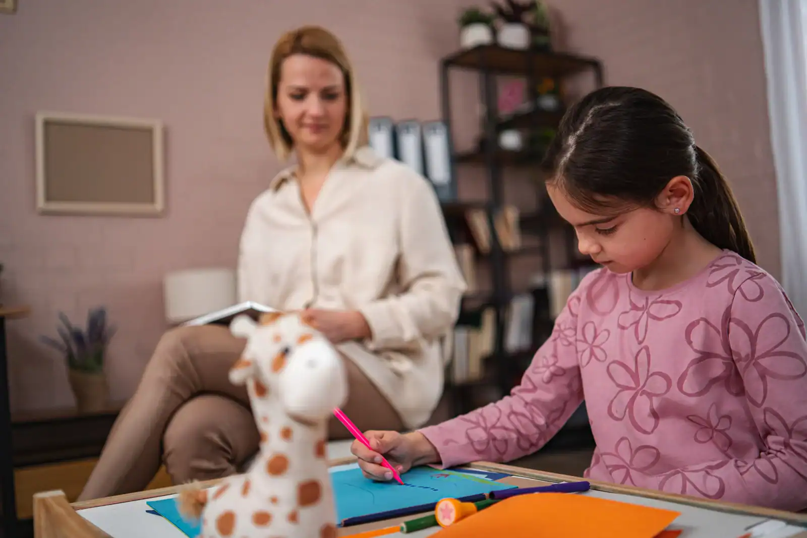 Child engaging in sensory profiling assessment with therapist in a clinical setting.
